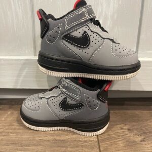 Infant sized gray, black, red Air Jordan basketball shoes.